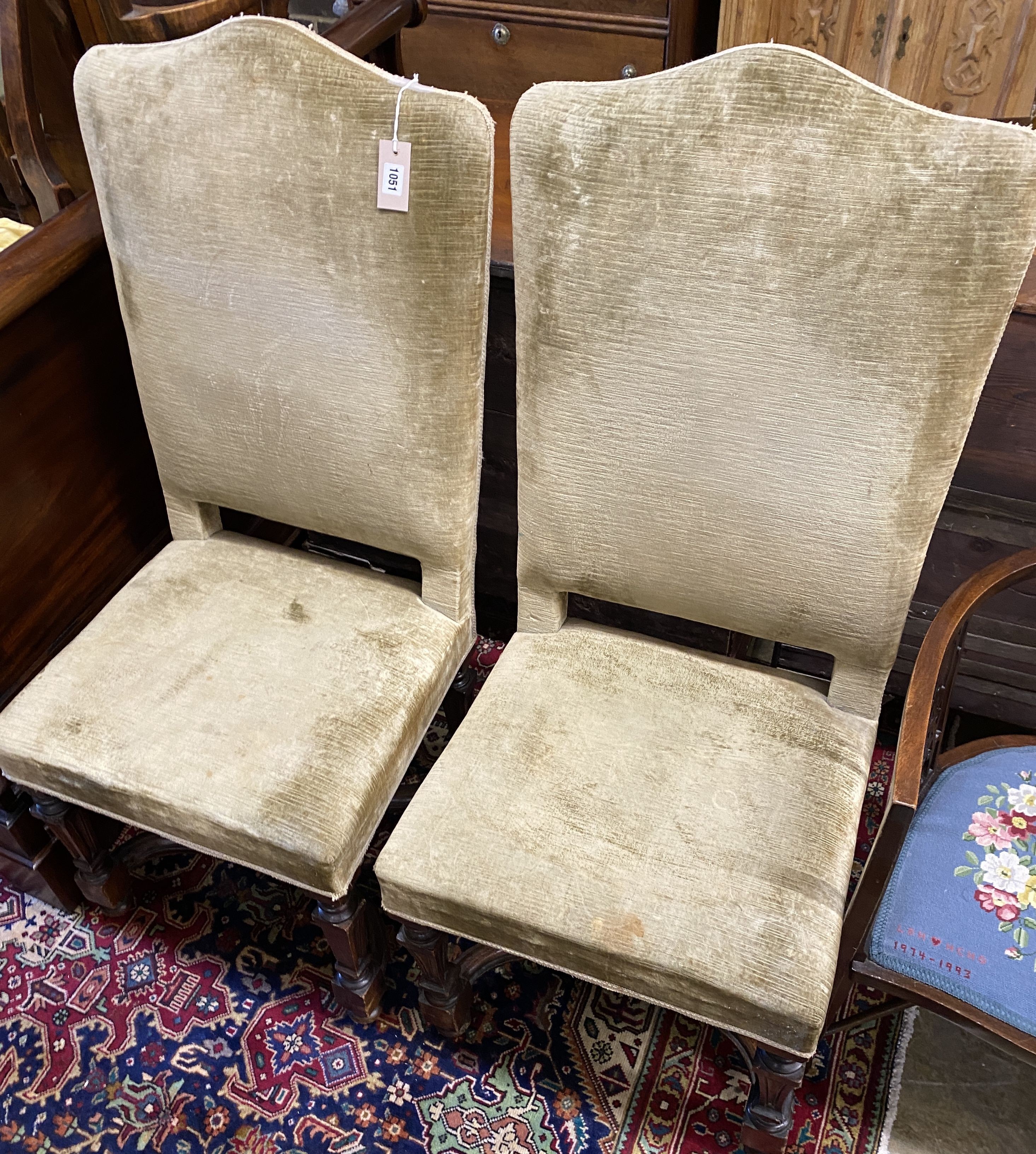 A pair of 17th century high back upholstered chairs (restorations), width 53cm, depth 46cm, height 121cm